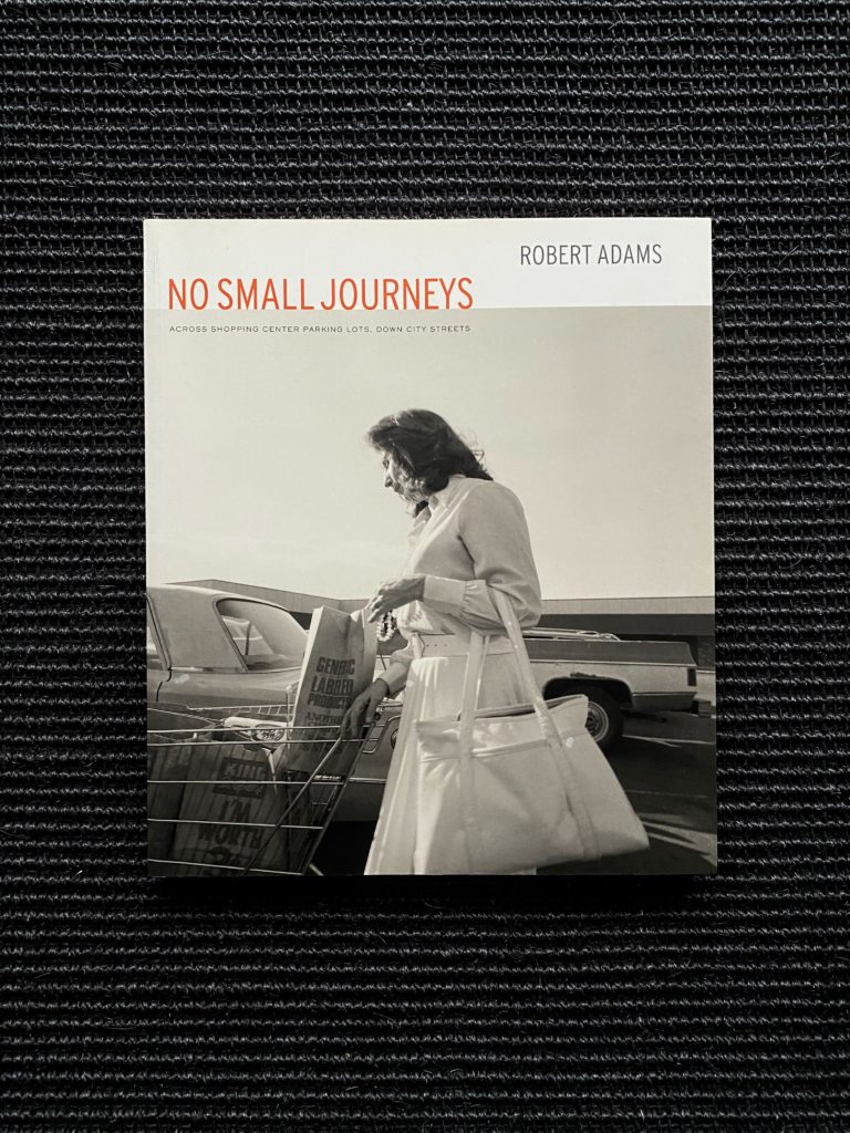 Robert Adams – No Small Journeys –                                 Across shopping center parking lots, down city streets